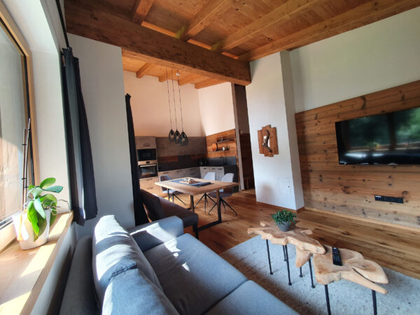 Sonniges Sofa am Panoramafenster mit Waldblick